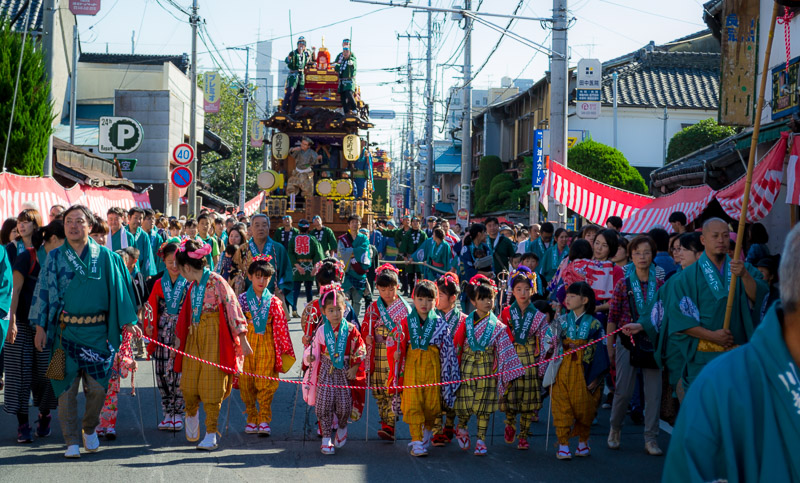 Kids leading a festival float around the city.